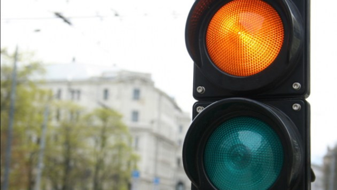 Traffic light with yellow and green lights