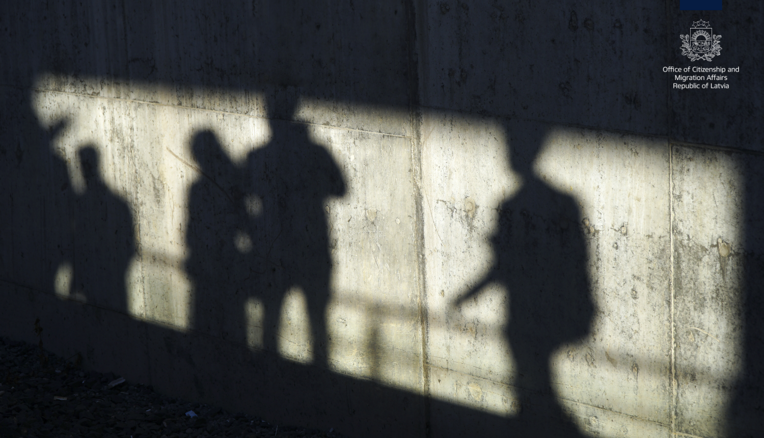 Cilvēku ēnas uz sienas an anglisko PMLP ģērboni